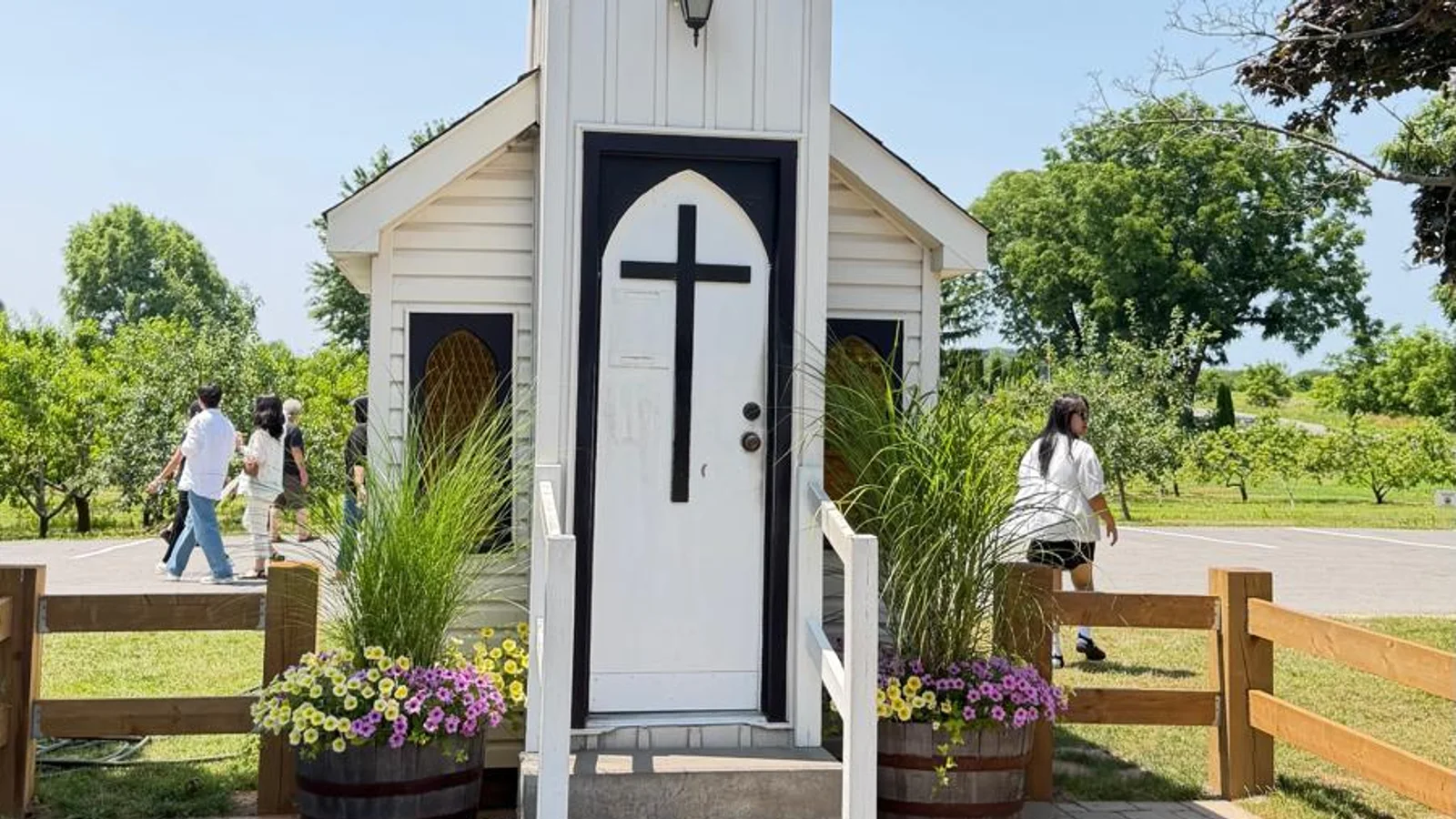 The Living Water Wayside Chapel on the Niagara Parkway, its door barely wider than the people walking past it