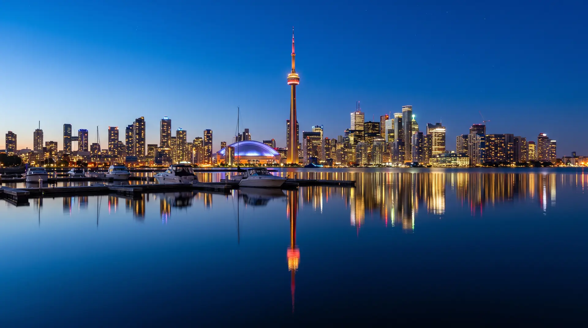 Toronto skyline at night with CN Tower reflected in the water, private city tour